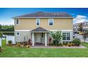 Beautiful two-story home with a covered porch and lush front yard landscaping at 3603 Sanctuary Dr, St Cloud, FL 34769
