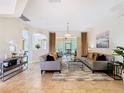 Bright living room boasts tile flooring, neutral paint, and a sliding glass door to the lanai at 4109 Vessel Ct, Kissimmee, FL 34746