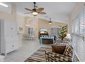 Spacious living room with vaulted ceiling, ceiling fans, tile flooring, and abundant natural light at 423 Paloma Dr, Davenport, FL 33837