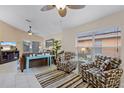 Comfortable living room featuring tile flooring, contemporary furniture, and abundant natural light at 423 Paloma Dr, Davenport, FL 33837