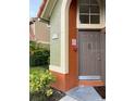 Close-up of unit 223's front door with lovely manicured shrubs at 429 Fountainhead Cir # 223, Kissimmee, FL 34741