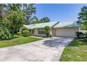 Charming home exterior with lush landscaping, a well-manicured lawn, and natural light at 4307 Oak Ct, St Cloud, FL 34769