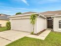 Exterior view showcasing the two-car garage, front entrance, and curb appeal at 440 Peppermill Cir, Kissimmee, FL 34758
