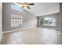 Bright and airy living room with tile flooring, large windows, a ceiling fan, and neutral paint at 440 Peppermill Cir, Kissimmee, FL 34758