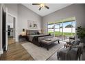 Staged main bedroom with a ceiling fan, sliding glass doors to patio, and doorway to the kitchen at 440 Peppermill Cir, Kissimmee, FL 34758