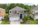 Aerial view of a lovely two-story home with a well-maintained yard and mature trees at 4697 Golden Beach Ct, Kissimmee, FL 34746