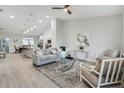 Open-concept living room with vaulted ceilings, tile floors, and stylish furnishings, leading into a kitchen and dining area at 515 Everest Way, Kissimmee, FL 34758