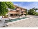 Stately multi-level house showcasing an elegant pool and an external spiral staircase at 550 Lake Otis Se Dr, Winter Haven, FL 33880