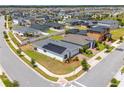 Aerial view of home with solar panels situated on a corner lot within a residential neighborhood at 6651 Syreeta Ln, Harmony, FL 34773