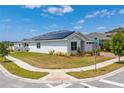 Corner lot home featuring solar panels, lush lawn and attractive landscaping at 6651 Syreeta Ln, Harmony, FL 34773