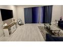 Bright and airy living room with modern furnishings, neutral paint, and elegant curtains for comfortable living at 7773 Spectrum Dr, Reunion, FL 34747