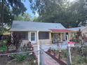 Exterior shot of a home, showcasing the front entrance and simple yard at 822 5Th St, Orlando, FL 32824