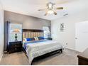 Cozy bedroom featuring a large bed, soft carpet, ceiling fan, and windows providing natural light at 824 Bloomingdale Dr, Davenport, FL 33897
