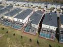 Aerial shot showing the property with a screened pool, adjacent to similar residences in a well-maintained community at 8974 Cabot Cliffs Dr, Davenport, FL 33896