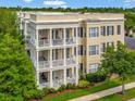Aerial view of a multi-story residential building with manicured landscaping and private balconies at 920 Spring Park St # 301, Celebration, FL 34747