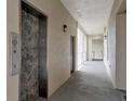 Hallway with an elevator, neutral walls, and doors, offering a modern and accessible space at 920 Spring Park St # 301, Celebration, FL 34747