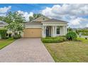 Charming one-story home with a brick-paved driveway and beautifully maintained front yard landscaping at 1598 Whitewood Ct, Kissimmee, FL 34747