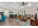 Open-concept living area featuring modern furnishings, tray ceiling, and abundant natural light at 1598 Whitewood Ct, Kissimmee, FL 34747