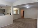 Open living room featuring neutral paint, carpeted floors, and an opening to the kitchen area at 1608 Columbia Arms Cir # 126, Kissimmee, FL 34741