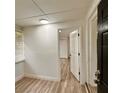 Bright room with laminate flooring and multiple doorways at 1615 Ne 9Th St, Ocala, FL 34470