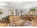Spacious living area with hardwood floors, plush seating, and stylish decor at 1704 Pine Ridge Dr, Davenport, FL 33896