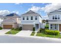 Inviting two-story home with a two-car garage, manicured lawn, and stepping stone pathway at 178 Aberdeen St, Davenport, FL 33896