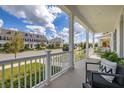 Inviting covered front porch with comfortable seating, providing a relaxing outdoor space at 2108 Celebration Blvd, Celebration, FL 34747