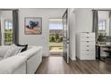 Bright living room showcasing modern decor and a view of the neighborhood from the open doorway at 2108 Celebration Blvd, Celebration, FL 34747