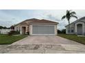 Charming one-story home featuring a screened garage and brick-paved driveway at 2646 Quarterdeck Ct, Kissimmee, FL 34743