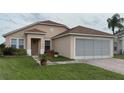 Charming one-story home featuring a screened garage and brick-paved driveway at 2646 Quarterdeck Ct, Kissimmee, FL 34743