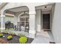 Inviting front porch with rocking chairs and a small table, perfect for relaxing at 2700 Palm Isle Way, Orlando, FL 32829