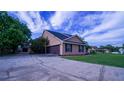 Spacious driveway leading to attached garage and well-maintained property exterior at 2851 Granada Blvd, Kissimmee, FL 34746