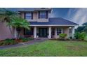 Inviting front entrance showcases meticulously landscaped yard and charming architecture at 2851 Granada Blvd, Kissimmee, FL 34746