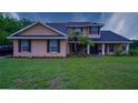 Charming two-story home featuring a well-manicured lawn and inviting curb appeal at 2851 Granada Blvd, Kissimmee, FL 34746