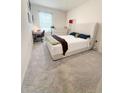 Bedroom with neutral carpet, natural light, simple desk, and comfortable padded headboard at 2915 Turnstone, St Cloud, FL 34773