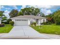 Charming single-story home featuring a manicured lawn and a two-car garage at 3161 Timberly Ln, Lakeland, FL 33810