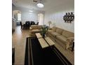 Inviting living room featuring tile floors, neutral paint, comfortable couches, and adjacent dining area at 324 Palermo St, Davenport, FL 33897
