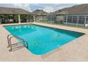 Sparkling community pool with poolside cabana and plenty of space for swimming and relaxing at 3267 Villa Way Cir, St Cloud, FL 34769
