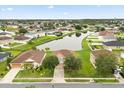 Aerial view of a home in a residential area with a scenic pond and lush green surroundings at 3335 Whistling Trl, St Cloud, FL 34772