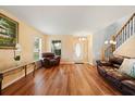 Inviting living room featuring hardwood floors, natural light, and neutral decor, ideal for relaxing at 3335 Whistling Trl, St Cloud, FL 34772