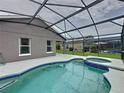 Relaxing screened-in pool and spa with ample patio space, perfect for entertaining friends and Gathering at 350 Scrub Jay Way, Davenport, FL 33896