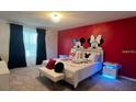Fun bedroom featuring a themed mural, plush carpet, and decorative pillows at 3878 Lana Ave, Davenport, FL 33897