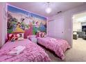 Delightful room with twin beds, vibrant wall art, and coordinated decor at 3878 Lana Ave, Davenport, FL 33897