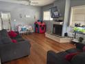 Comfortable living room featuring hardwood floors, fireplace, and natural light at 419 Ohio Ave, St Cloud, FL 34769