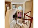 Bright foyer with a high ceiling and a carpeted staircase with white banisters and double doors at 4368 Fox Glen Loop, Kissimmee, FL 34746