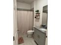 Bathroom featuring granite countertop, modern fixtures, and a tiled shower at 522 Feltrim Manor Rd, Haines City, FL 33844