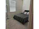 Cozy bedroom featuring plush carpet, a comfortable bed, and ample natural light at 522 Feltrim Manor Rd, Haines City, FL 33844