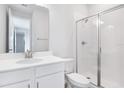 Bright bathroom featuring a glass-enclosed shower, vanity, and white tile at 530 Summit River Dr, Apopka, FL 32712