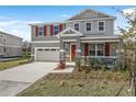 Charming two-story home featuring a red front door, stone accents, neutral siding, and a well-manicured lawn at 540 Summit River Dr, Apopka, FL 32712