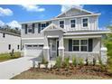 Charming two-story home with a two-car garage, gray siding and lovely landscaping at 555 Summit River Dr, Apopka, FL 32712